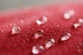 Water droplets on  a  jacket of red waterproof fabric Royalty Free Stock Photo