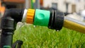 Water droplets leaking through damaged water hose pipe connection. Water waste, gardening equipment Royalty Free Stock Photo