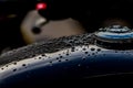 Water droplets on motorcycle fuel tank. Royalty Free Stock Photo