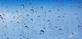 Water droplets perspective through window glass surface against blue sky good for multimedia content Royalty Free Stock Photo