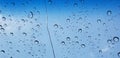 Water droplets perspective through window glass surface against blue sky good for multimedia content Royalty Free Stock Photo