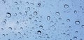 Water droplets perspective through window glass surface against blue sky good for multimedia content Royalty Free Stock Photo