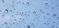 Water droplets perspective through window glass surface against blue sky good for multimedia content Royalty Free Stock Photo