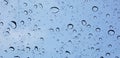 Water droplets perspective through window glass surface against blue sky good for multimedia content Royalty Free Stock Photo