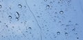 Water droplets perspective through window glass surface against blue sky good for multimedia content Royalty Free Stock Photo