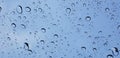 Water droplets perspective through window glass surface against blue sky good for multimedia content Royalty Free Stock Photo