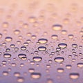 Water droplets rest on a smooth surface, creating a pattern of varying sizes. The Royalty Free Stock Photo