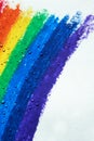 There are drops of water dripping over a rainbow with crayons. Royalty Free Stock Photo