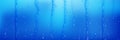 Water droplets and streams on blue surface Royalty Free Stock Photo