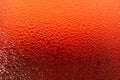 Water Droplets Texture of a Glass of Vibrant Red Chilled Drink