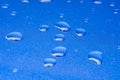 Water droplets on twinkling blue background