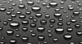 Waaigenerateder droplets of varying sizes scattered on a smooth, dark surface. The droplets are Royalty Free Stock Photo