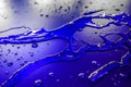 Water droplets on waterproof surface of the car vinyl film are blue purple Royalty Free Stock Photo