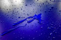 Water droplets on waterproof surface of the car vinyl film are blue purple Royalty Free Stock Photo