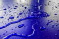 Water droplets on waterproof surface of the car vinyl film are blue purple Royalty Free Stock Photo