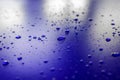 Water droplets on waterproof surface of the car vinyl film are blue purple. Texture Royalty Free Stock Photo