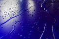 Water droplets on waterproof surface of the car vinyl film are blue purple Royalty Free Stock Photo