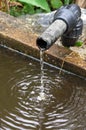 Water dropping in a drinking trough Royalty Free Stock Photo