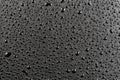 Water drops on abstract flat black hydrophobic surface macro background Royalty Free Stock Photo