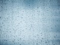 Water drops on glass window over blue sky Royalty Free Stock Photo