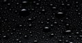 Water drops on black glass surface, closeup Royalty Free Stock Photo