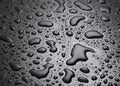 Water drops on black surface.