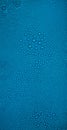 Water drops on blue background. Fresh clean texture, cold surface. Large, small drops of water on the glass