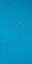 Water drops on blue background. Fresh clean texture, cold surface. Large, small drops of water on the glass Royalty Free Stock Photo