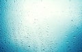 Water drops on blue background / Drops of rain on glass , rain drops on clear window / Blue Abstract Water Drops Background / Royalty Free Stock Photo