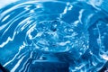 Water drops on blue surface. Water ripple background. Splashes from a drop of water. Raindrops on a blue background. The texture