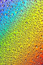 Water drops on a bright rainbow background, close-up Royalty Free Stock Photo