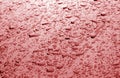 Water drops on car surface in red tone Royalty Free Stock Photo