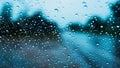 Water drops on car window glass after the rain with blur street Road background in thailand Royalty Free Stock Photo