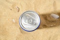 Water drops on a cold beer or soda can top agains sea sand on a sunny day. Drinking on the go beverages in aluminum cans with pull Royalty Free Stock Photo