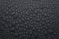 Water drops on dark grey background as elegant pattern with formless and round drops, top view.