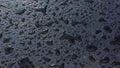 Water drops on a dark plastic surface Royalty Free Stock Photo