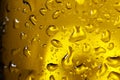 Water drops on dark yellow glass surface, macro view Royalty Free Stock Photo