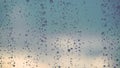 Water drops descend on the glass window in rainy.