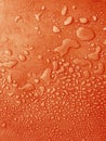 water drops of different sizes on a orange surface, drops texture, rain on orange tile, rain texture, red refreshing background, Royalty Free Stock Photo