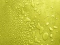 water drops of different sizes on a yel surface, drops texture, rain on lime tile, rain texture, yellow refreshing background,