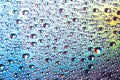 Water drops on dvd media, water drops on colorful background Royalty Free Stock Photo