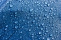 Rain Water droplets on blue fiber waterproof fabric. Royalty Free Stock Photo