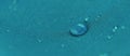 Water drops on the fabric. Rain Water droplets on blue fiber waterproof fabric. Water drops pattern over a waterproof