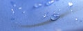 Water drops on the fabric. Rain Water droplets on blue fiber waterproof fabric. Water drops pattern over a waterproof