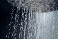 Water drops flowing from the shower head, close up. AI generated Royalty Free Stock Photo