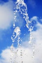 Water drops from the fountain against blue summer sky Royalty Free Stock Photo