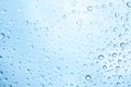Water drops on glass and blue background Royalty Free Stock Photo