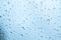 Water drops on glass and blue background Royalty Free Stock Photo