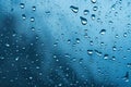 Water drops on glass with blue background. Rain drops on window Royalty Free Stock Photo