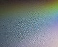 Water drops on glass with colorful rainbow background. Morning dew on the window with a refractive reflection Royalty Free Stock Photo